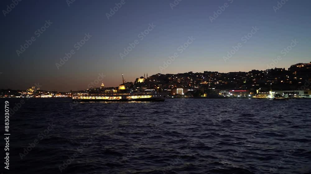 Serene night scene of a ferry boat sailing on the calm waters of the Bosphorus Serene night scene of a ferry boat sailing on the calm waters of the Bosphorus