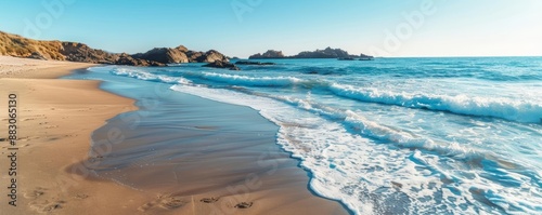 A calm beach with gentle waves, mild breeze, tranquil and relaxing coastal landscape