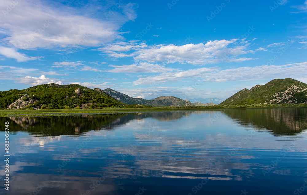 Beautiful water landscape on Lake Skadar with reflection of mountains in the water. Montenegro Beautiful water landscape on Lake Skadar with reflection of mountains in the water. Montenegro