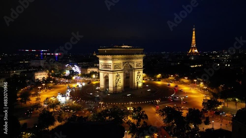 Paris, Arc de Triomphe Triumphal Arch at Chaps Elysees at night, Paris, France. Drone view, Eiffel Tower in the background.  Architecture and landmarks of Paris. Postcard of Paris
