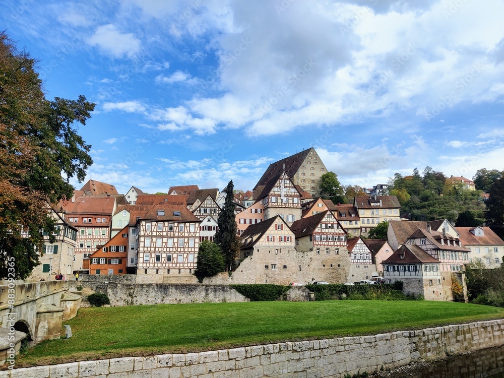 Cityscape of a swabian city in south germany with green grass, a river, cloudy sky and half-timbered houses Cityscape of a swabian city in south germany with green grass, a river, cloudy sky and half-timbered houses