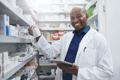 Black man, tablet and portrait of pharmacist with drugs for stock, inventory or quality inspection. Face, pharma and happy medical worker with medicine for prescription order, health info or storage photo