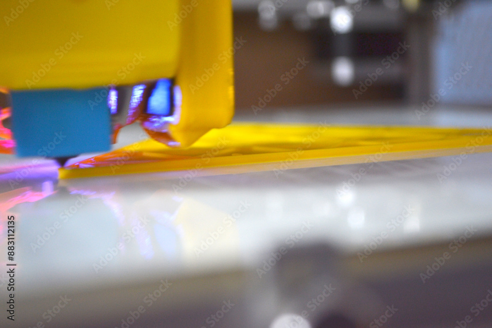 3D printer printing a model. Equipment of a 3D printer during the process of printing a model from molten plastic