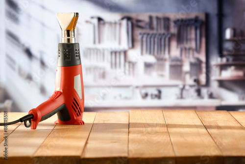 Fotografi Heat gun tool on wooden work table in craft workshop