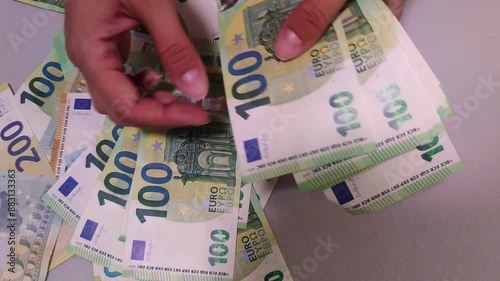 View of female hands counting euro banknotes on a light background
