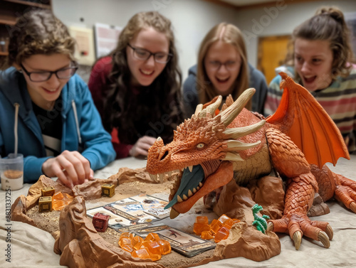 Four friends are enthusiastically playing a board game featuring a large dragon figure and various game pieces on a detailed game board photo