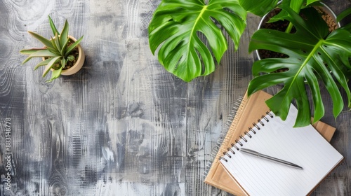 Blank Notebook with Pen and Green Plants.