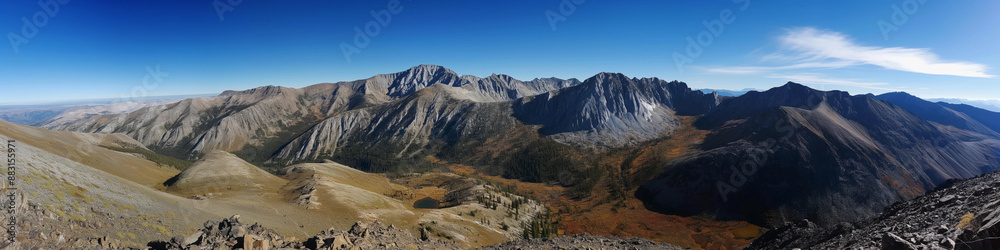 Naklejka premium Wide panoramic photo of the mountains against the blue sky