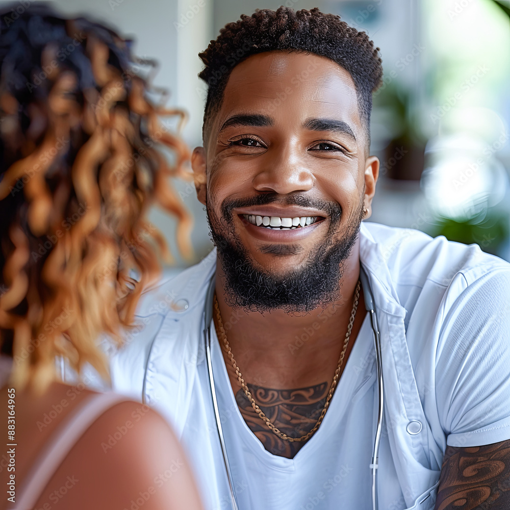 Smiling Male Doctor with Stethoscope Talking to a Patient in a Modern Medical Clinic During a Checkup Appointment Smiling Male Doctor with Stethoscope Talking to a Patient in a Modern Medical Clinic During a Checkup Appointment