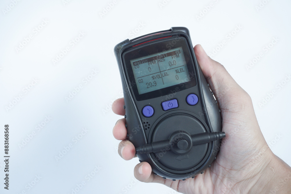 Human's hand holding the Portable Gas Detector for detect combustible gas , flammable gas , toxic gas and oxygen depletion in a confined spaces before starting work. Human's hand holding the Portable Gas Detector for detect combustible gas , flammable gas , toxic gas and oxygen depletion in a confined spaces before starting work.