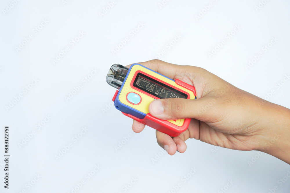 disposable electronic cigarette in a man's hand on white background. The concept of modern alternative smoking, vaping and nicotine disposable electronic cigarette in a man's hand on white background. The concept of modern alternative smoking, vaping and nicotine