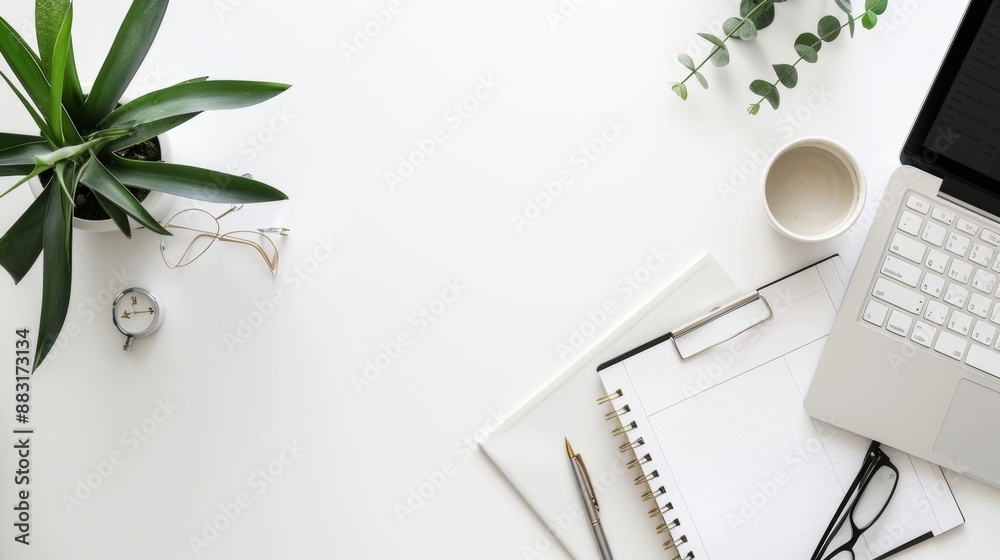 Minimalist White Desk Workspace with Laptop, Notebook, and Coffee.