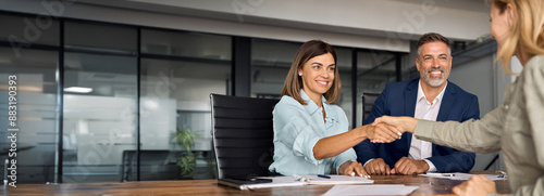 фотографія Latin business team of woman and European man shaking hands with colleagues, partners or employees, signing a contract