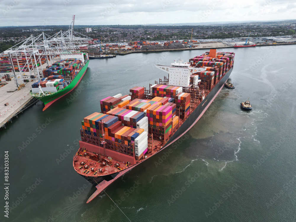 Fototapeta premium Aerial top view container ship full load container for logistics import, export, shipping or transportation concept background.