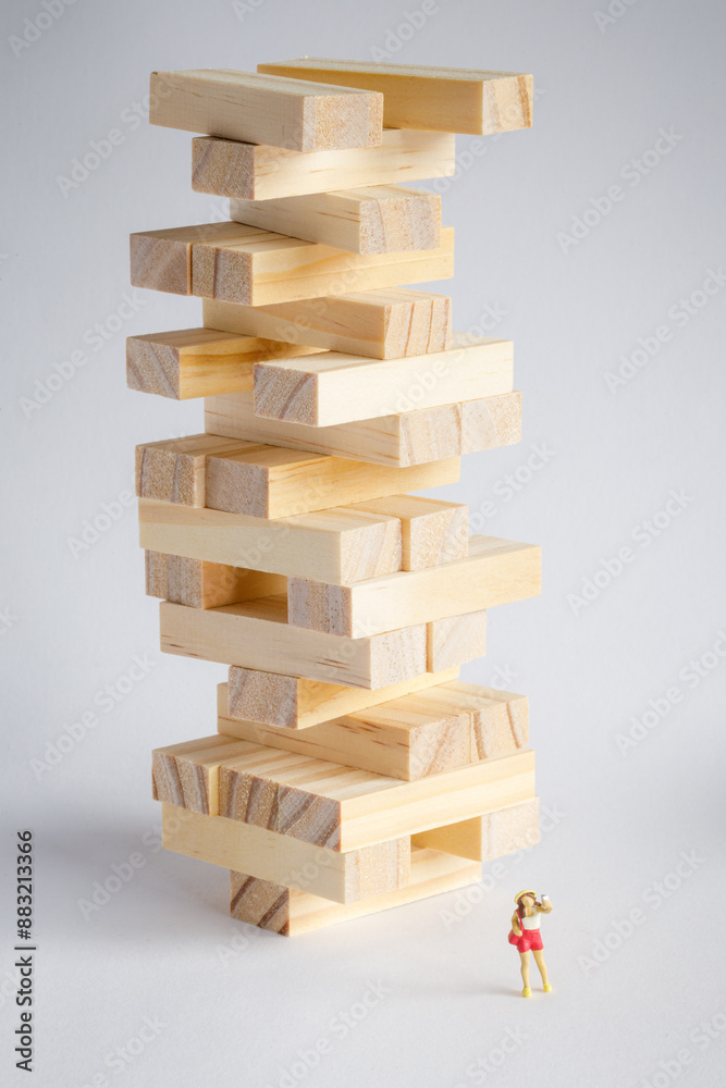 stack of wooden blocks as a tourist attraction and a mini figure taking a selfie 