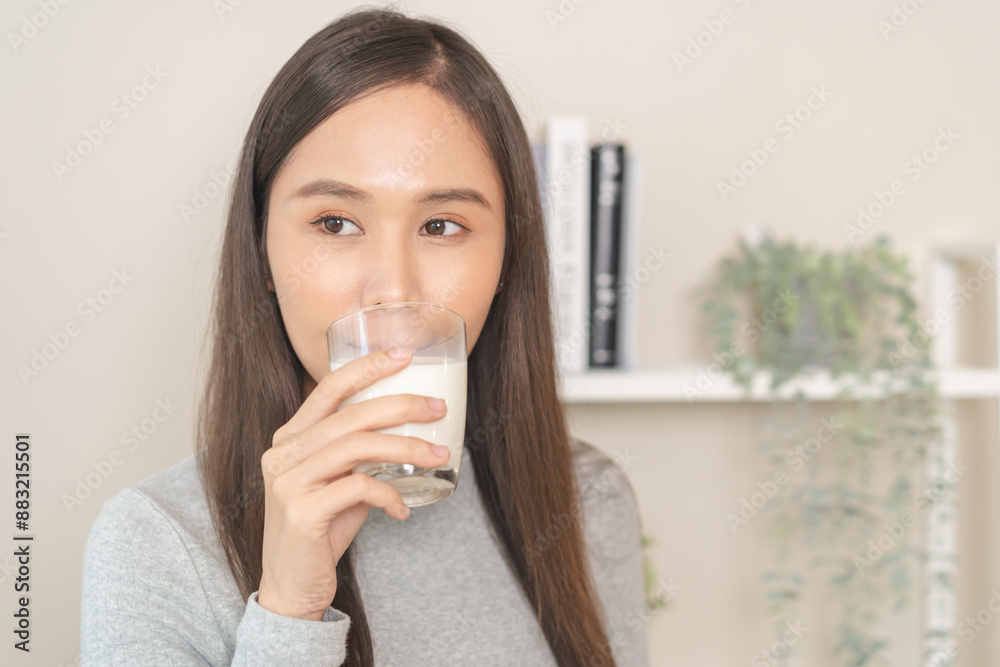 Health care asian young woman, girl drinking a glass of white fresh, dairy soy milk for calcium, vitamin wholesome good nutrition in the morning, isolated on white background product healthy people. Health care asian young woman, girl drinking a glass of white fresh, dairy soy milk for calcium, vitamin wholesome good nutrition in the morning, isolated on white background product healthy people.