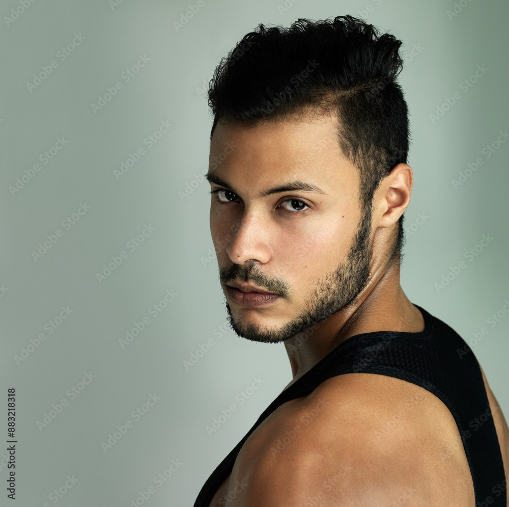 Obraz premium Man, serious portrait and athlete in studio, strong muscle and body training on gray background. Male person, bodybuilder and confidence for fitness results, mockup space and training or workout