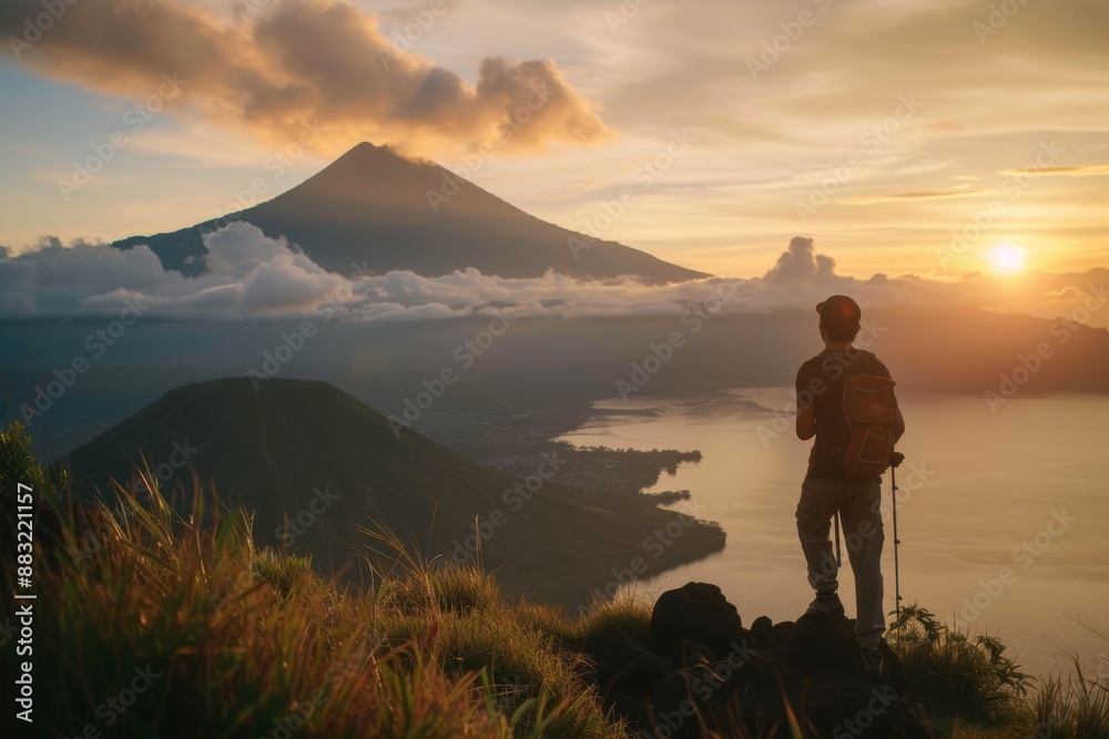 Sunset on mountain One man, standing high on beautiful mountain Batur in sunset alone Sunset on mountain One man, standing high on beautiful mountain Batur in sunset alone