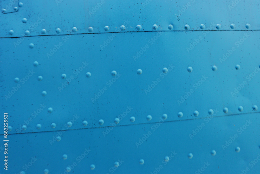 Fototapeta premium Photo of a metal surface with rivets.