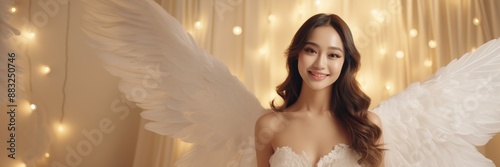 A smiling asian female holy angel in heavenly lingerie with a bright white golden glowing background, ai generated © Seussi