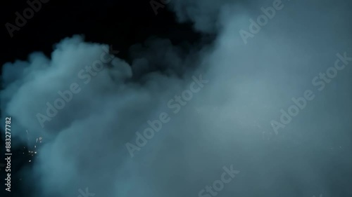 Large explosion with billowing smoke and fire in a landscape setting.