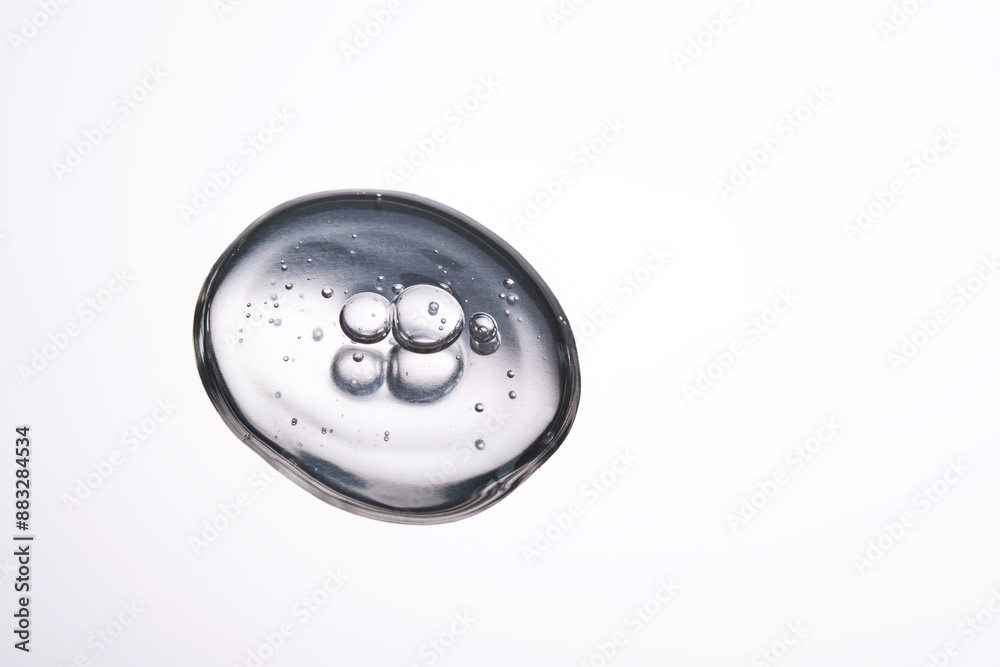 A smear of cosmetic gel close-up on a gray background. Appetizing texture with bubbles. A smear of cosmetic gel close-up on a gray background. Appetizing texture with bubbles.