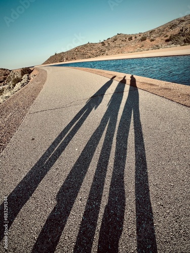 The shadow of 3 girls walking at the aqueduct in Lancaster, California, United states 