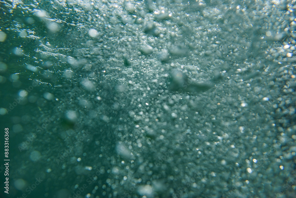 The glow of many bubbles under the sea water