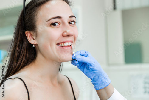 Free Download Smiling woman having tooth shade matched by dentist - GFXLoad