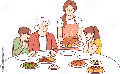 Family celebration of thanksgiving with joint dinner and delicious turkey cooked according to catholic traditions. Caring mother serves poultry meat baked in oven during thanksgiving dinner