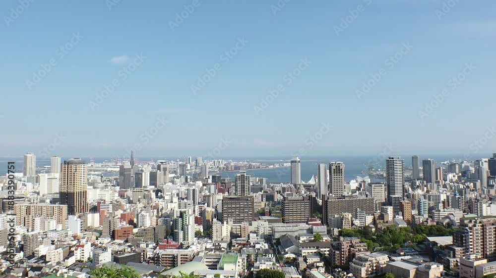 KOBE, HYOGO, JAPAN - JUNE 2024 : Aerial high angle view of Kobe city and Kobe port in daytime. View of buildings and street around Kobe port tower and Sannomiya station. 4K time lapse shot. KOBE, HYOGO, JAPAN - JUNE 2024 : Aerial high angle view of Kobe city and Kobe port in daytime. View of buildings and street around Kobe port tower and Sannomiya station. 4K time lapse shot.