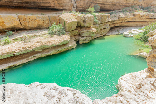 Green lake waters in the middle of Wadi Shab canyon, Tiwi, sultanate Oman photo