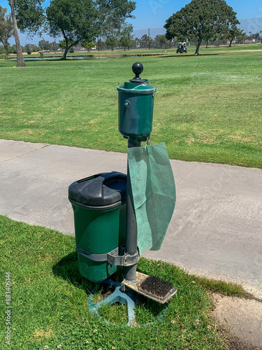 Golf ball  and club washer with golf shoe brush cleaner at a golf course.