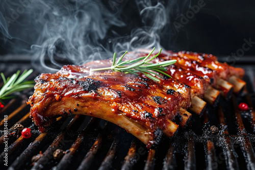 Grilled barbeque ribs with smoke in the air on dark background. Recipe food barbeque concept.
