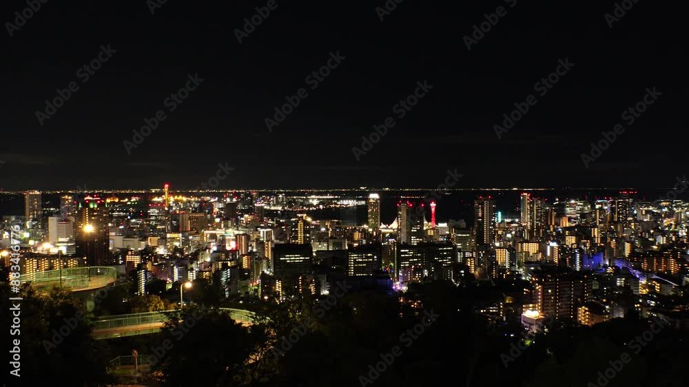 KOBE, HYOGO, JAPAN - JUNE 2024 : Aerial high angle view of Kobe city and Kobe port at night. View of buildings and street around Kobe port tower and Sannomiya station. 4K time lapse shot. KOBE, HYOGO, JAPAN - JUNE 2024 : Aerial high angle view of Kobe city and Kobe port at night. View of buildings and street around Kobe port tower and Sannomiya station. 4K time lapse shot.