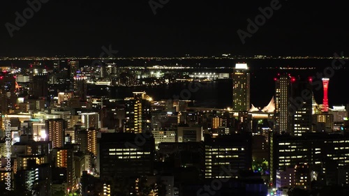 Wallpaper Mural KOBE, HYOGO, JAPAN - JUNE 2024 : Aerial high angle view of Kobe city and Kobe port at night. View of buildings and street around Kobe port tower and Sannomiya station. 4K time lapse shot. Torontodigital.ca