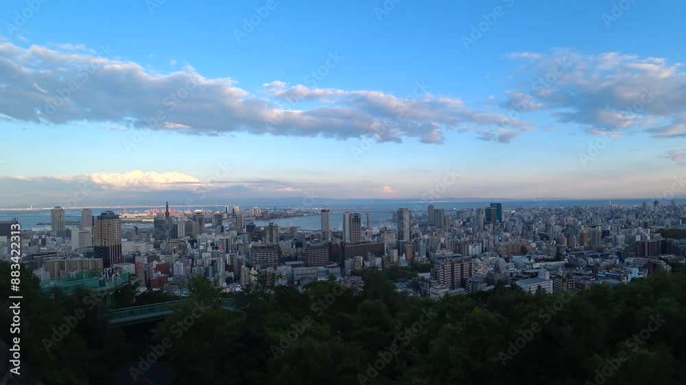 KOBE, HYOGO, JAPAN -JUN 2024 : Aerial high angle view of Kobe city and Kobe port in sunset. View of buildings and street around Kobe port tower and Sannomiya station. 4K time lapse shot, dusk to night KOBE, HYOGO, JAPAN -JUN 2024 : Aerial high angle view of Kobe city and Kobe port in sunset. View of buildings and street around Kobe port tower and Sannomiya station. 4K time lapse shot, dusk to night