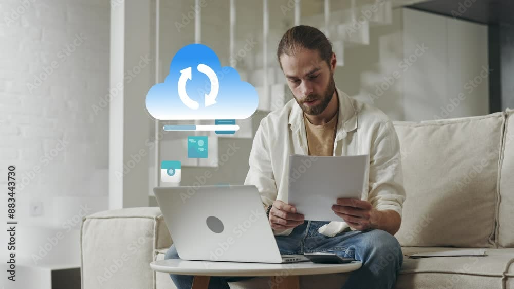 Caucasian man uploading data to cloud from living room