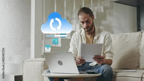 Caucasian man uploading data to cloud from living room