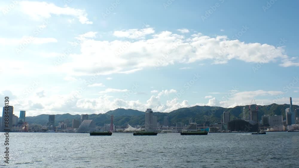 KOBE, HYOGO, JAPAN - JUNE 2024 : Scenery around Kobe port in daytime. View of buildings at Meriken park and Sannomiya downtown area. Travel and tourism concept video. 4K time lapse shot. KOBE, HYOGO, JAPAN - JUNE 2024 : Scenery around Kobe port in daytime. View of buildings at Meriken park and Sannomiya downtown area. Travel and tourism concept video. 4K time lapse shot.