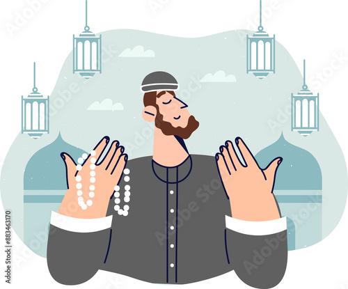 Islamic man praying doing hajj in holy month of ramadan or eid al-fitr, stands near mosques with lanterns. Islamic guy professes islam and reads prayers from karan describing life of allah photo