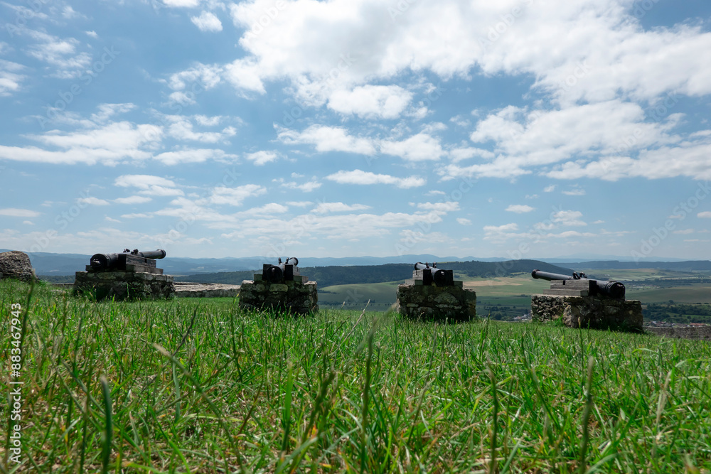 Naklejka premium A historical cannon at the Spis castle in Slovakia symbolically aimed behind the walls to defend it