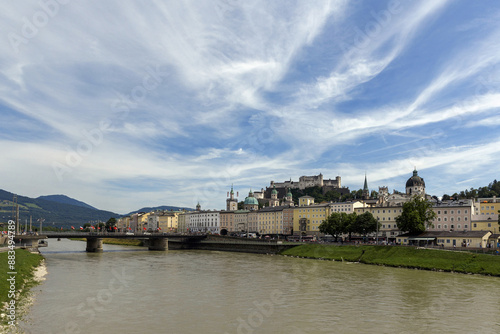 Salzburg, Austria - July 14, 2023: High angle and summer view of bridge on Salzach River against buildings of Hohensalzburg Fortress 