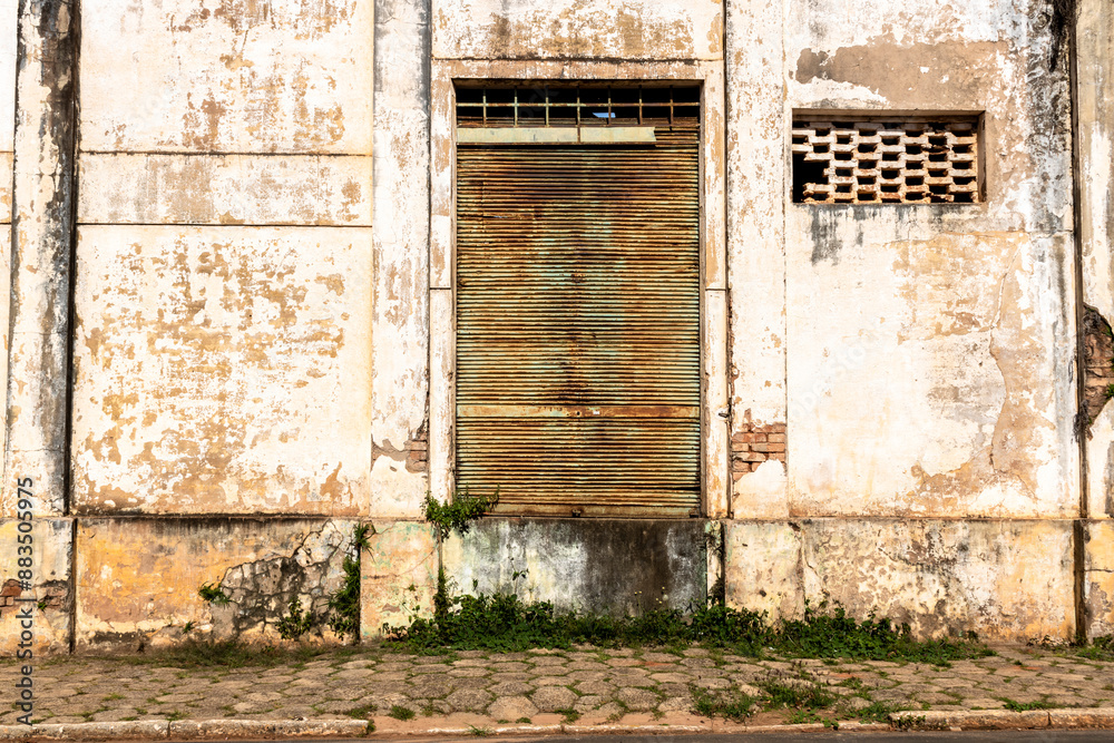 Facade of an old industrial warehouse that is next to an abandoned railway, on the little city in Brazil Facade of an old industrial warehouse that is next to an abandoned railway, on the little city in Brazil