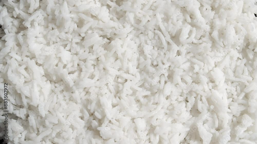 Overhead view of cooked rice rotating. Close up on white rice viewed from the top. Rice background. Overhead view of cooked rice rotating. Close up on white rice viewed from the top. Rice background.