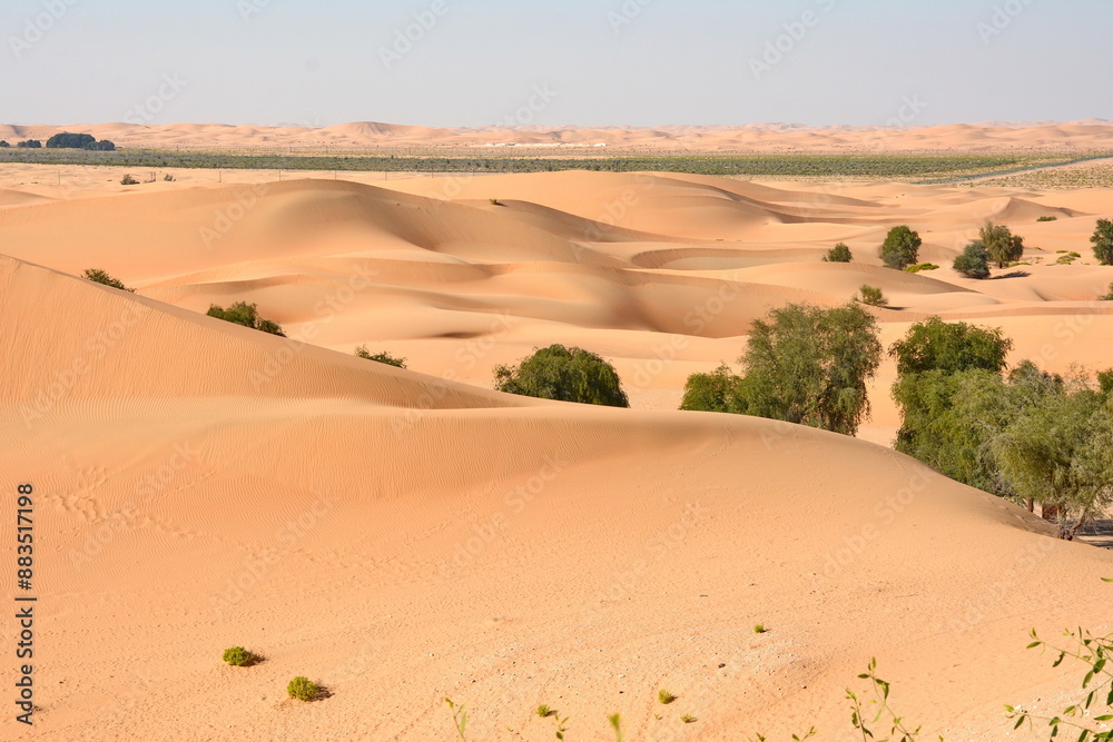 Sunset over the desert of Al Khatim in Abu Dhabi, Emirates. Golden Sand Dune Desert Landscape Panorama. Beautiful sunset over the sand dunes in the Al Khatim in Abu Dhabi, Emirates Sunset over the desert of Al Khatim in Abu Dhabi, Emirates. Golden Sand Dune Desert Landscape Panorama. Beautiful sunset over the sand dunes in the Al Khatim in Abu Dhabi, Emirates