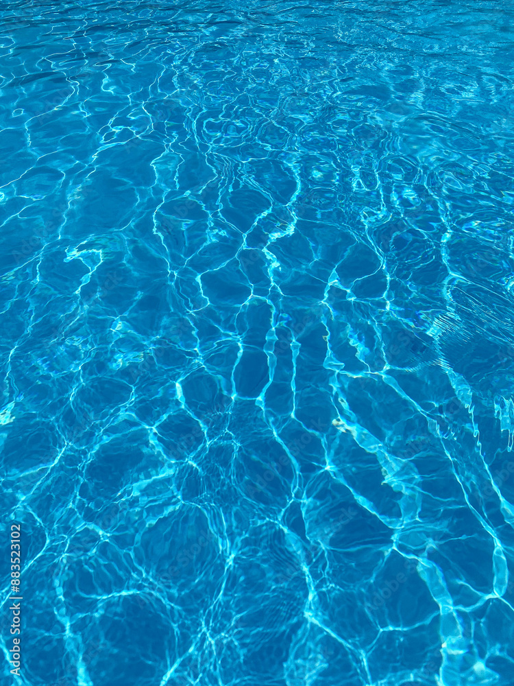 The water shimmers with varying shades of blue, reflecting the sunlight in gentle ripples. The water shimmers with varying shades of blue, reflecting the sunlight in gentle ripples.