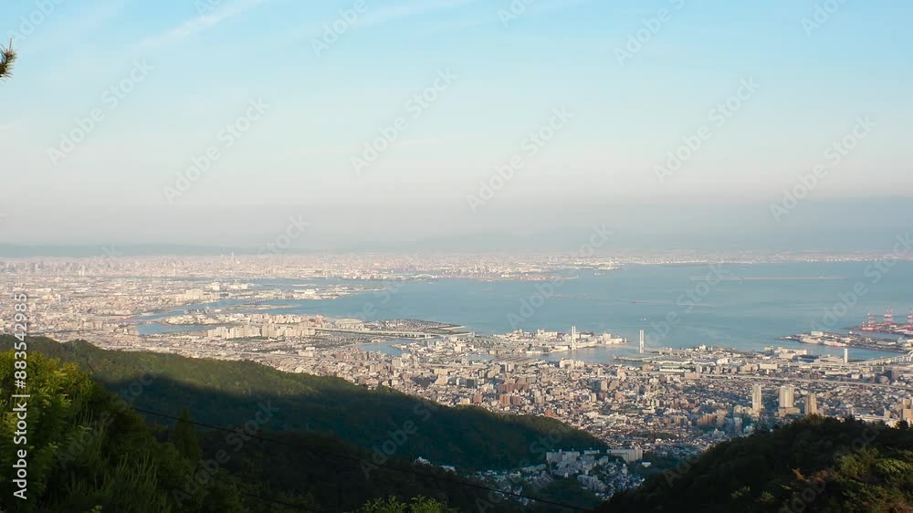 KOBE, HYOGO, JAPAN - JUN 2024 : Aerial high angle panoramic view around Kobe city, Kobe port, Osaka city and Osaka bay. View from top of Rokkosan (Mt. Rokko). Time lapse shot in sunset. KOBE, HYOGO, JAPAN - JUN 2024 : Aerial high angle panoramic view around Kobe city, Kobe port, Osaka city and Osaka bay. View from top of Rokkosan (Mt. Rokko). Time lapse shot in sunset.