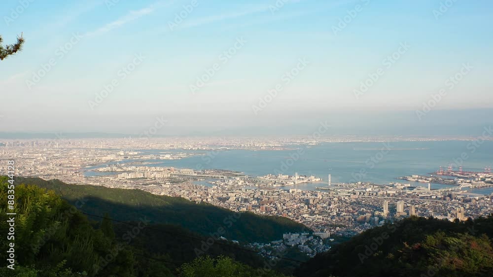 KOBE, HYOGO, JAPAN - JUN 2024 : Aerial high angle panoramic view around Kobe city, Kobe port, Osaka city and Osaka bay. View from top of Rokkosan (Mt. Rokko). Time lapse shot in sunset. KOBE, HYOGO, JAPAN - JUN 2024 : Aerial high angle panoramic view around Kobe city, Kobe port, Osaka city and Osaka bay. View from top of Rokkosan (Mt. Rokko). Time lapse shot in sunset.