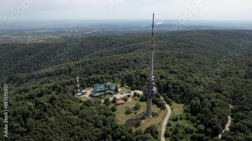 Backward reveal aerial shot of Irishki Venac Tower in Frushka Gora national park on sunny day. Serbia. photo